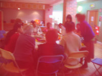 group of women around table at vine centre taken through fabric